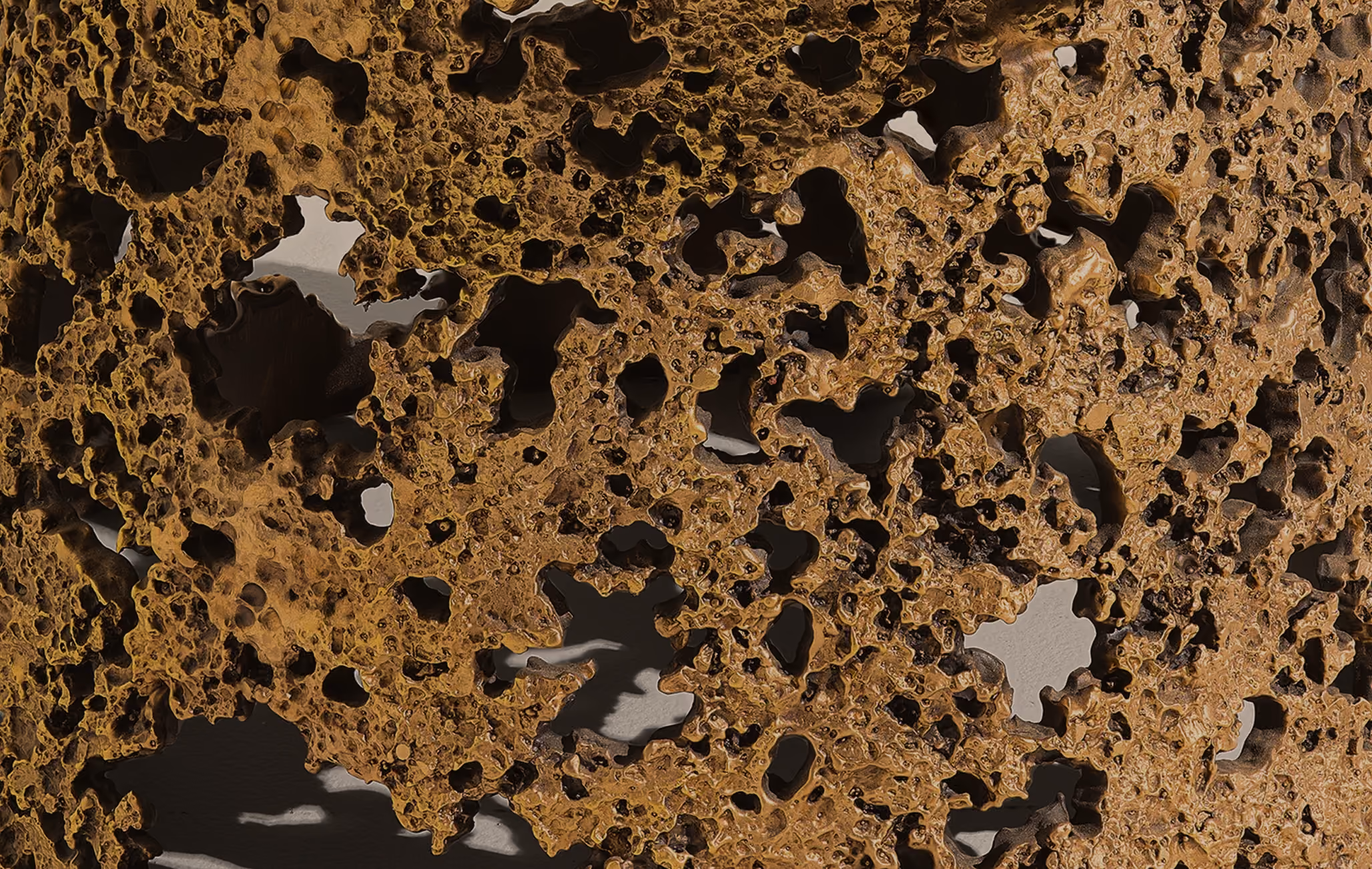 Close-up of heavily corroded and rusted metal surface with irregular holes and textured edges.