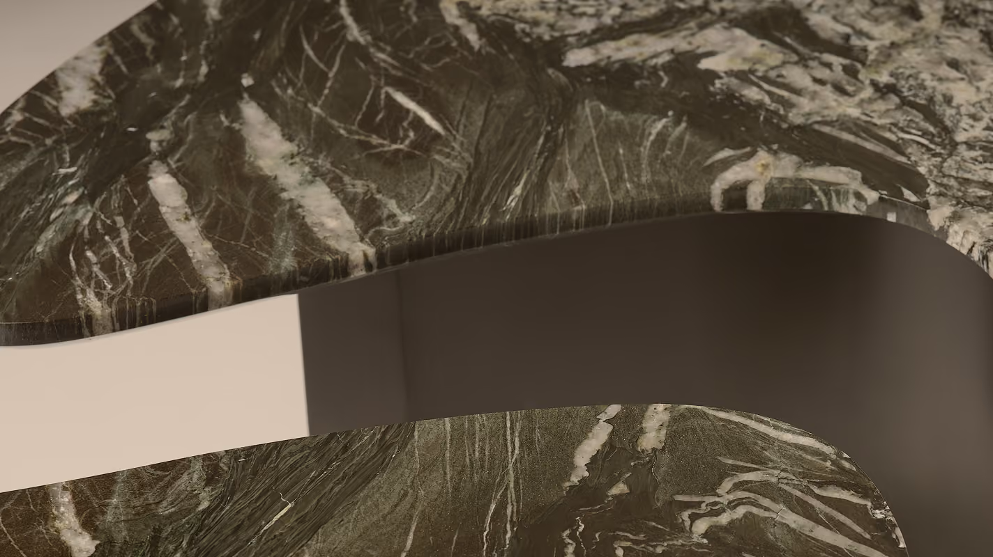 Close-up of a dark green marble surface with white and light gray veining, featuring smooth curved edges and a polished finish.