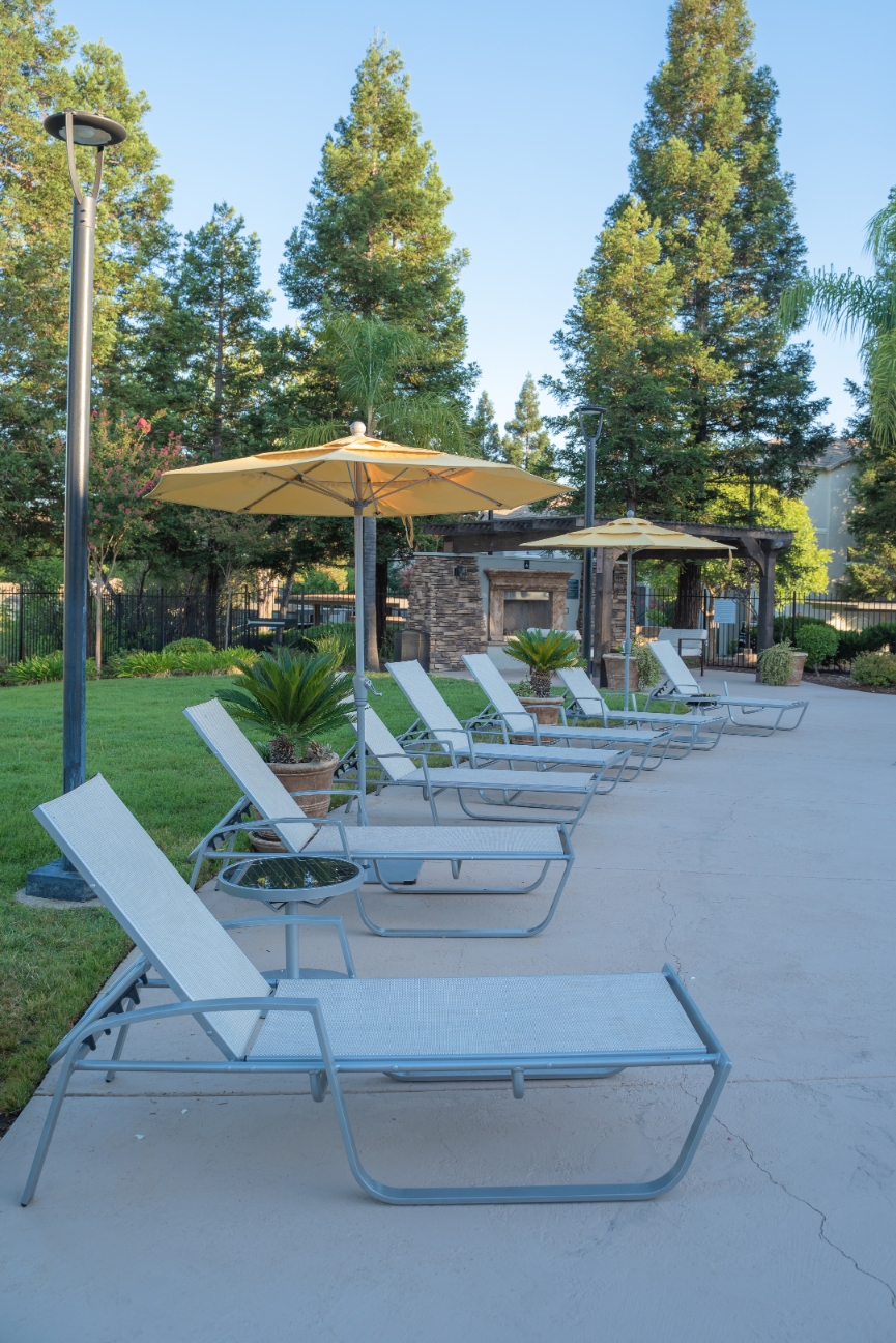 Lounge chairs by swimming pool