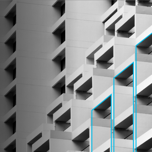 Close-up of a modern building's exterior with repeating geometric balconies and shadows in grayscale.
