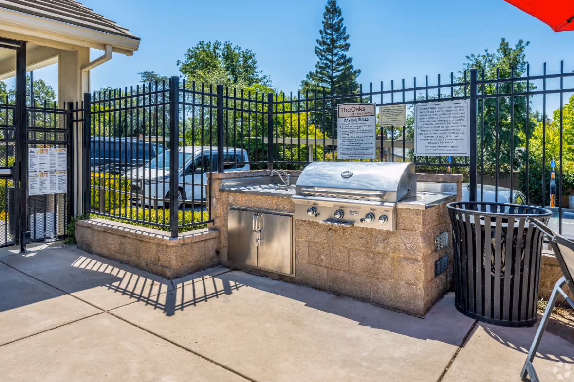 Exterior of Oaks at Hackberry BBQ area with stainless steel grill