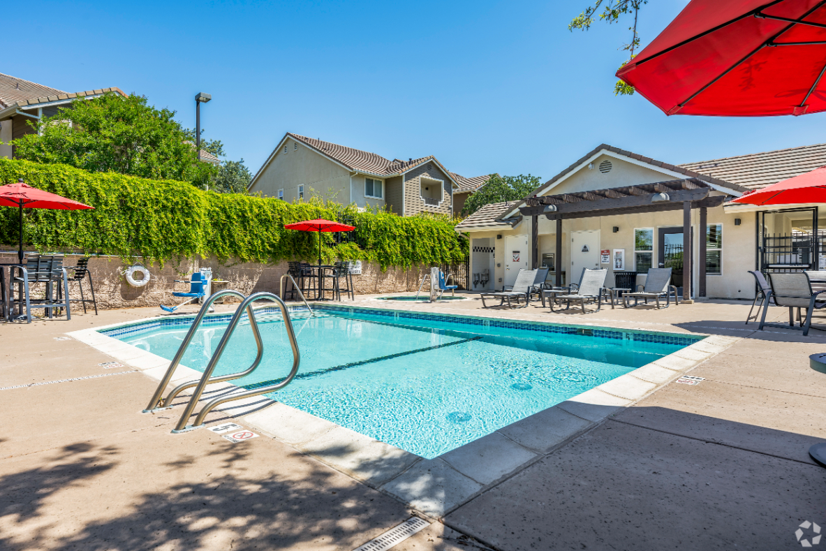 Swimming pool with lounge chairs and umbrellas