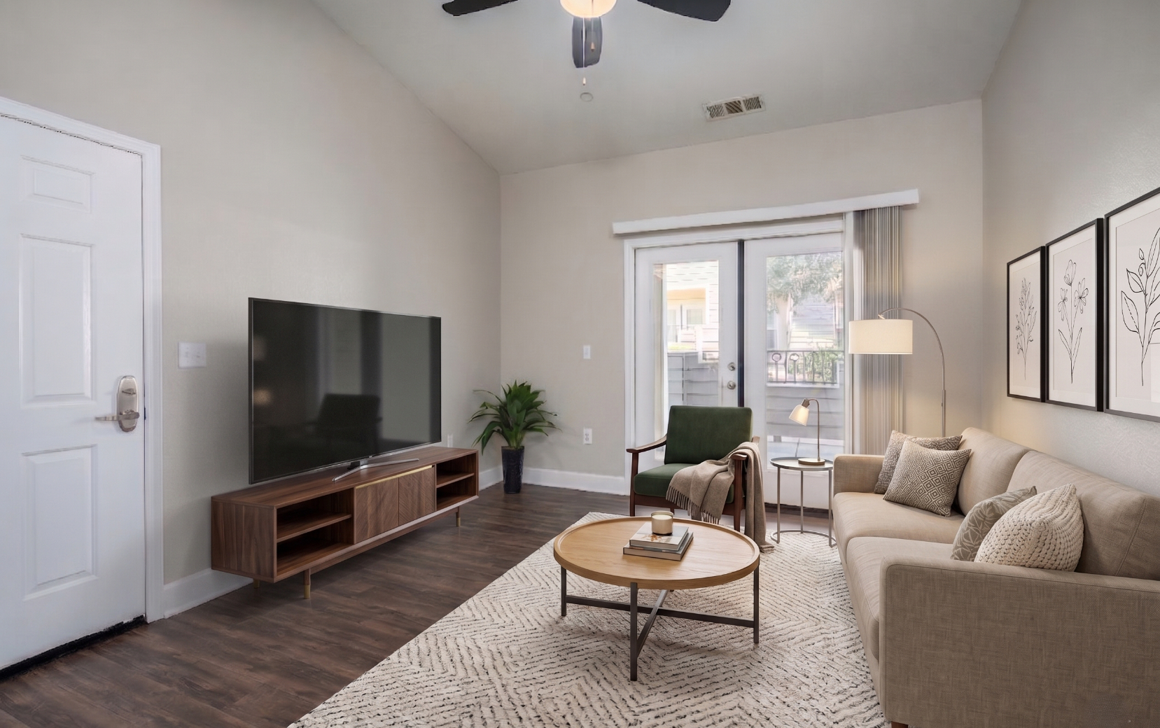 Living area with sofa, coffee table, tv, and doors to patio