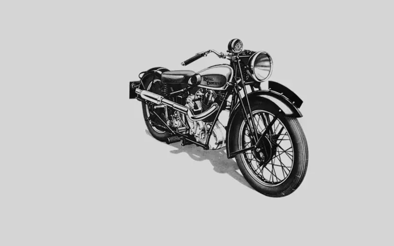 Černobílý obrázek vintage motocyklu s nápisem Paul Dartell na nádrži.
