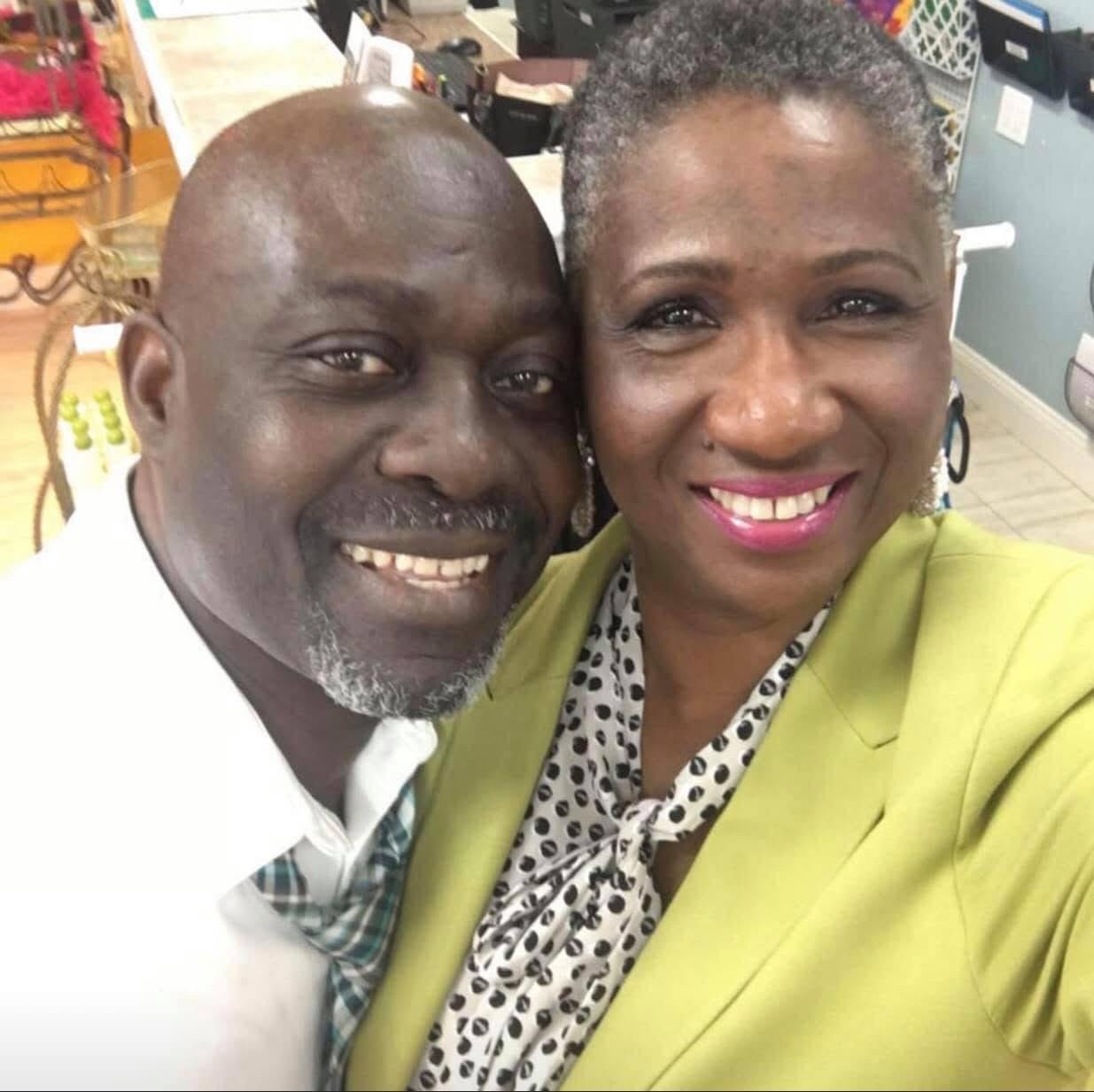 Close-up of a smiling middle-aged man and woman posing together indoors. Clients of Curasev