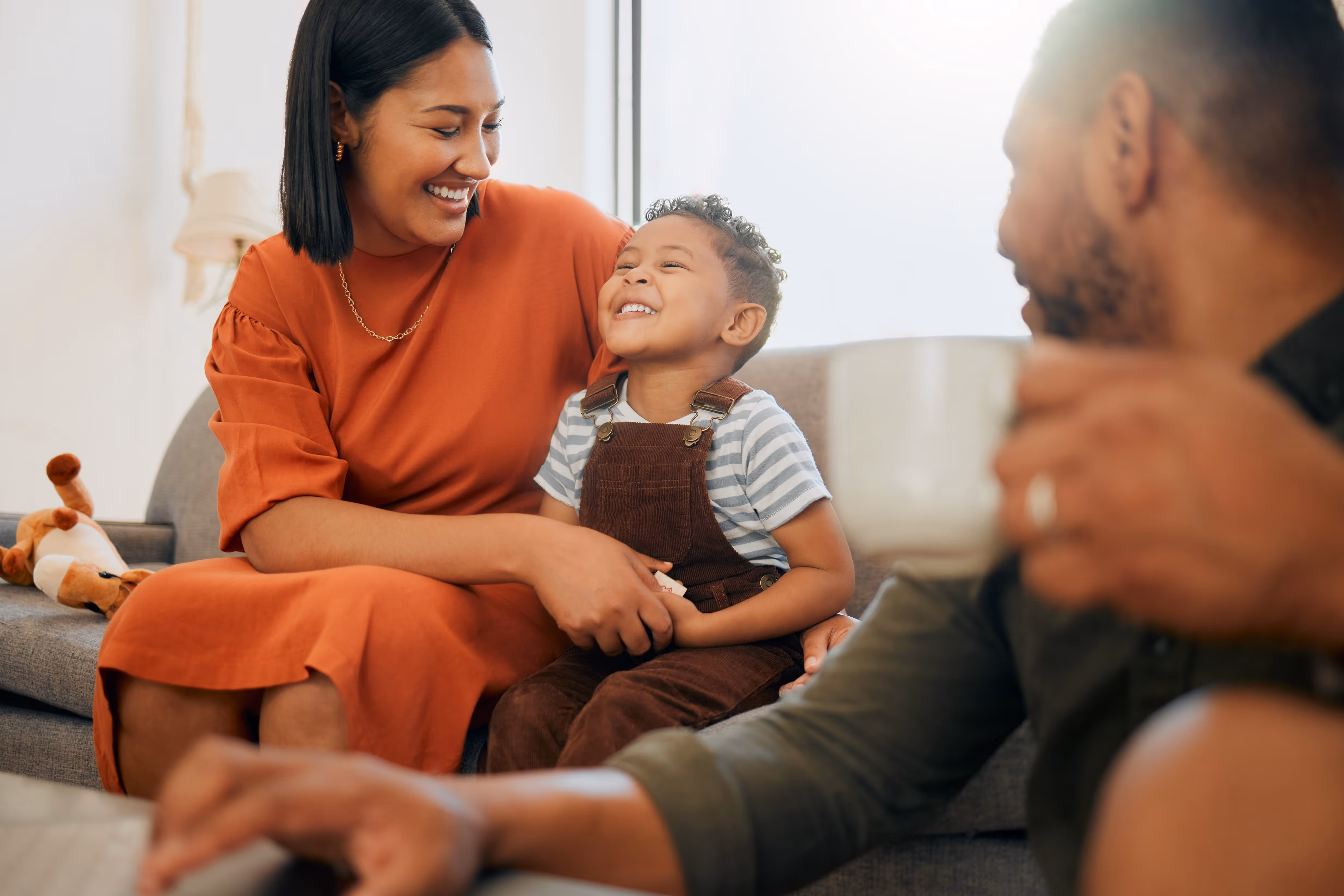 Mom and son smiling on a couch stock image