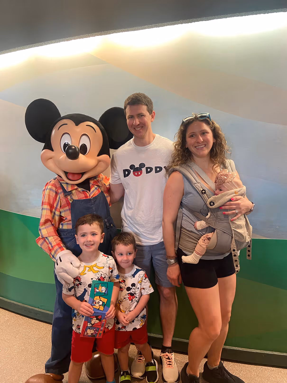 William Keller and his family posing for a picture with Mickey Mouse