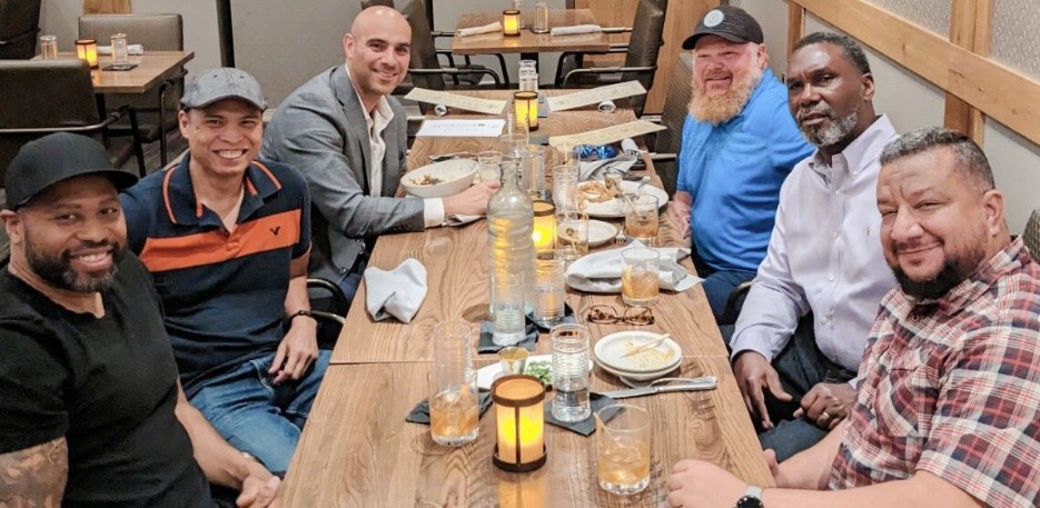 CNF employees dining together at wooden table during team lunch gathering