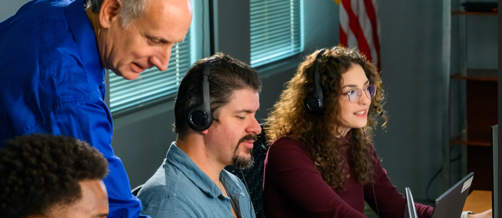 Cyber security team monitoring network threats in office with headsets and computers