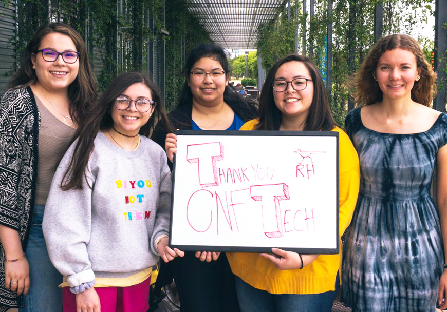 Students at hackathon holding thank you sign for CNF sponsor
