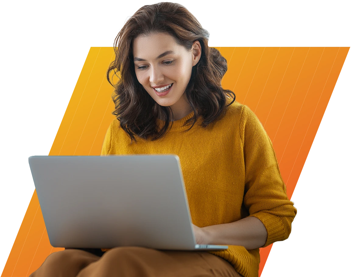 Smiling woman in mustard sweater using a laptop with an orange gradient background.