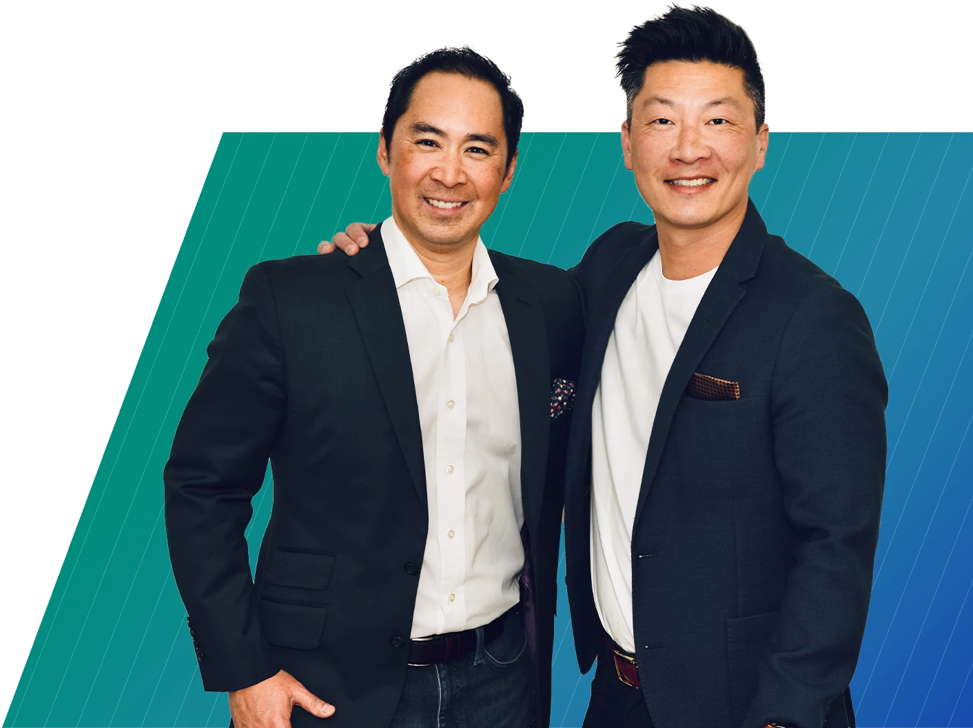 Two smiling men in dark blazers and casual shirts pose together against a teal and blue background.