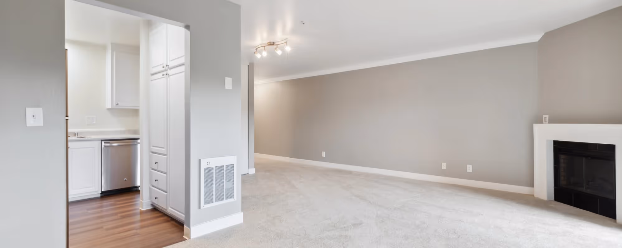 living room with fireplace and kitchen entrance