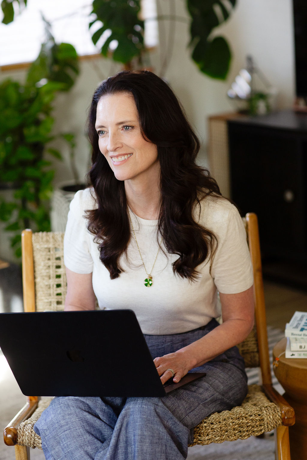 Tami Robinson takes notes on her laptop as she coaches and listens to a client.