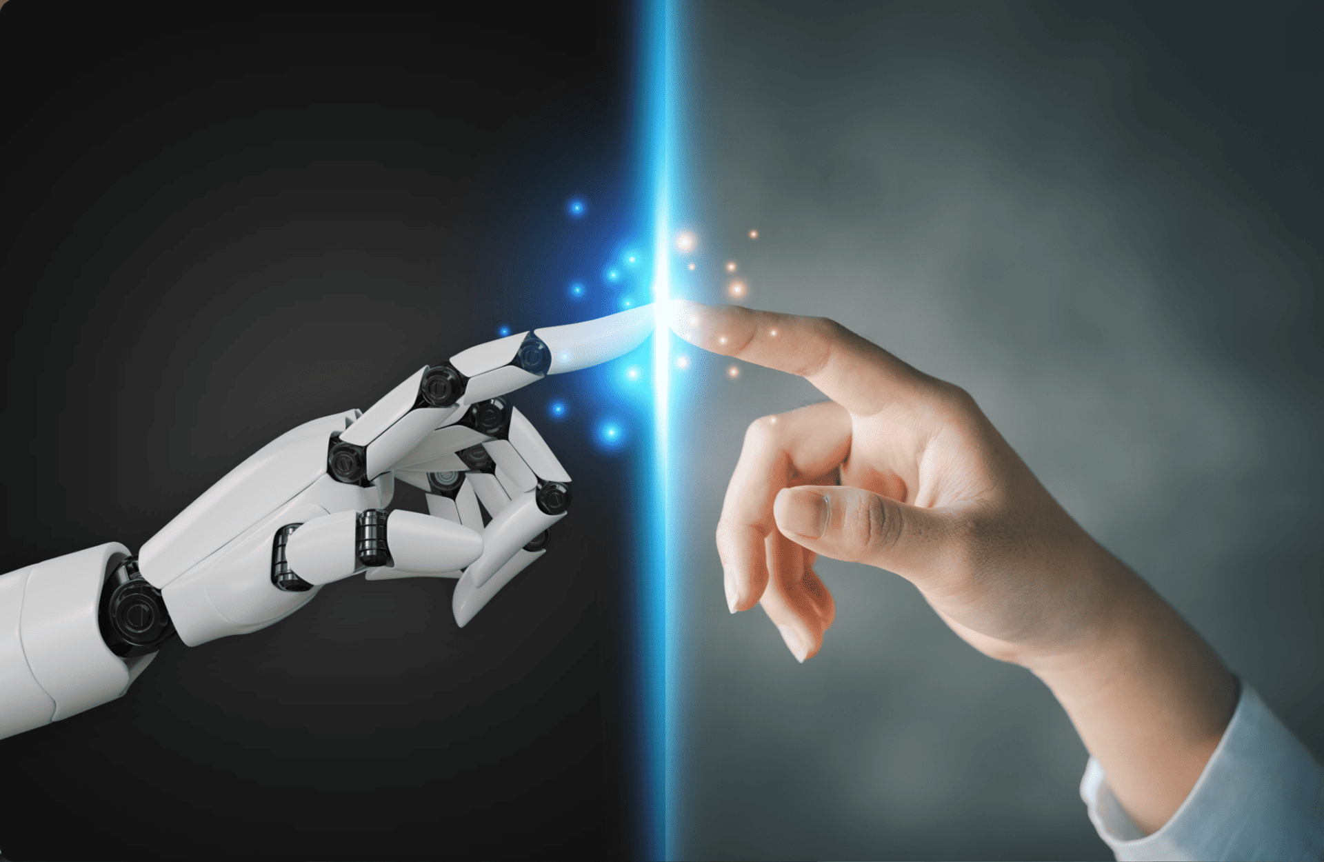 A robotic hand and a human hand reach towards each other, almost touching at the fingertips, creating a spark of blue light. Contrasting dark and light background.