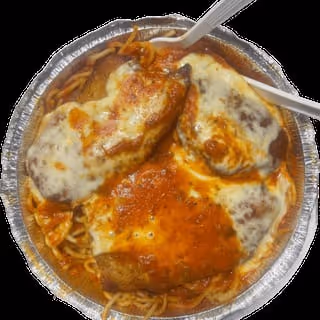 Takeout container with spaghetti topped with melted cheese and tomato sauce on breaded chicken pieces.
