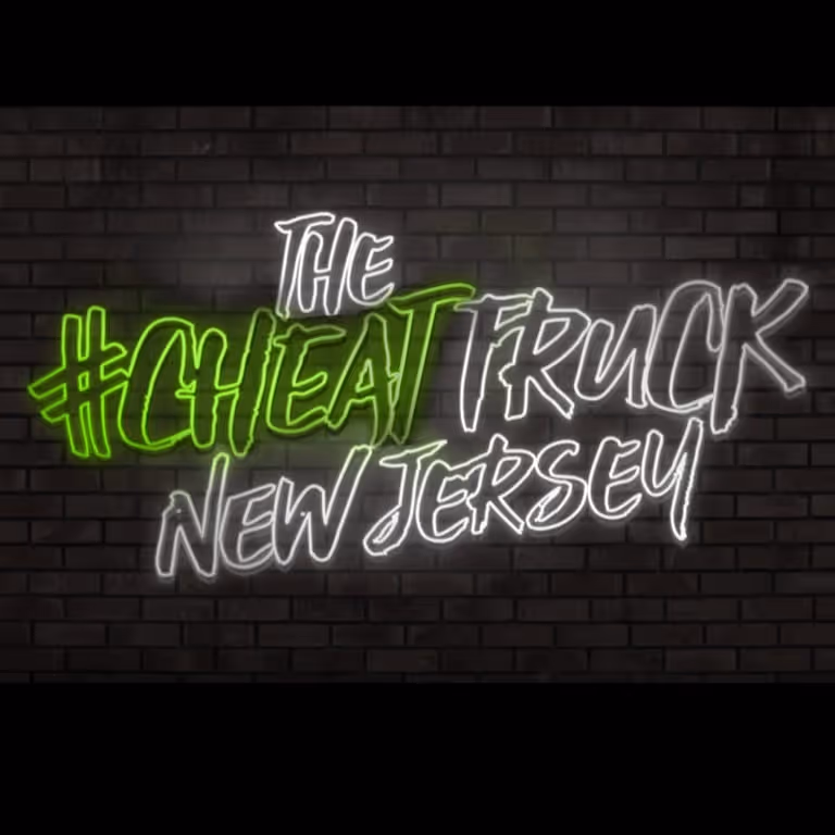 Neon sign on a brick wall displaying 'The #Cheat Truck New Jersey' with 'Cheat' highlighted in green.