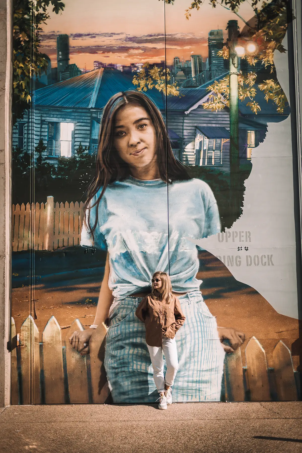 Portrait in front of a large mural at Brisbane Powerhouse