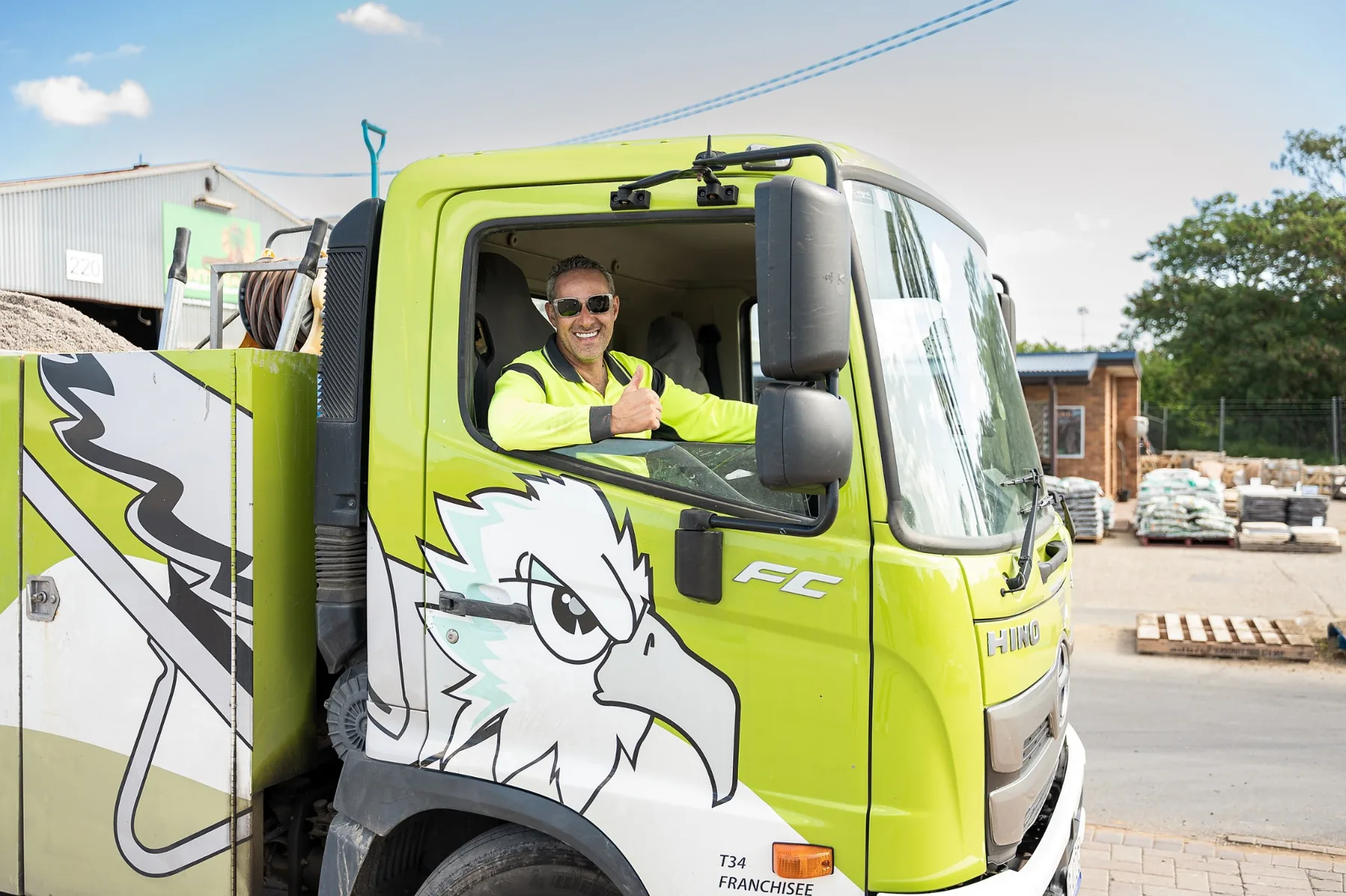 Concrete Taxi driver in a branded green truck at a Brisbane job site