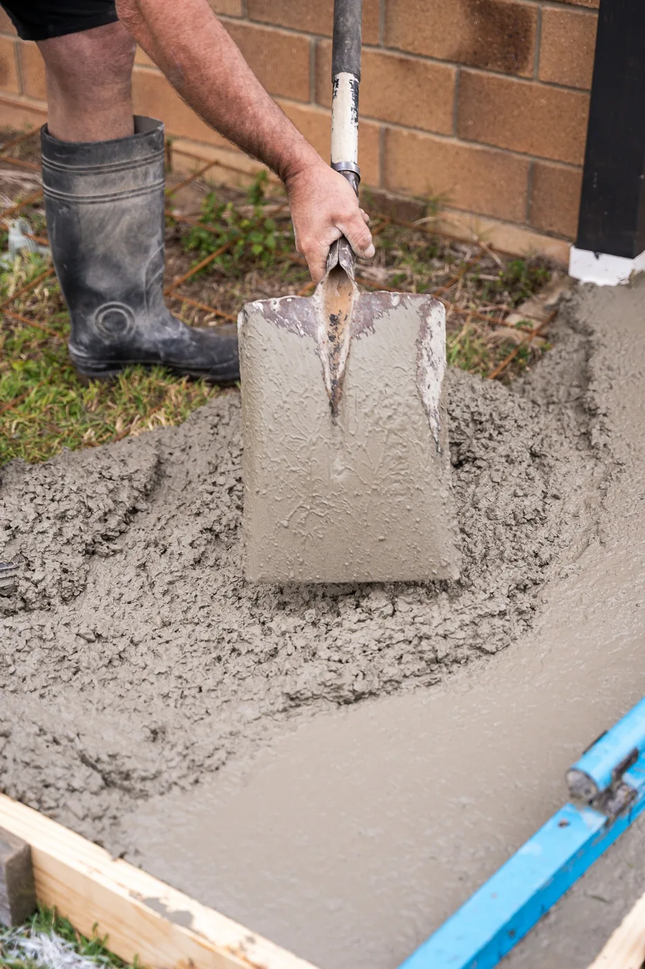 Close-up of a shovel and fresh concrete during a Concrete Taxi job