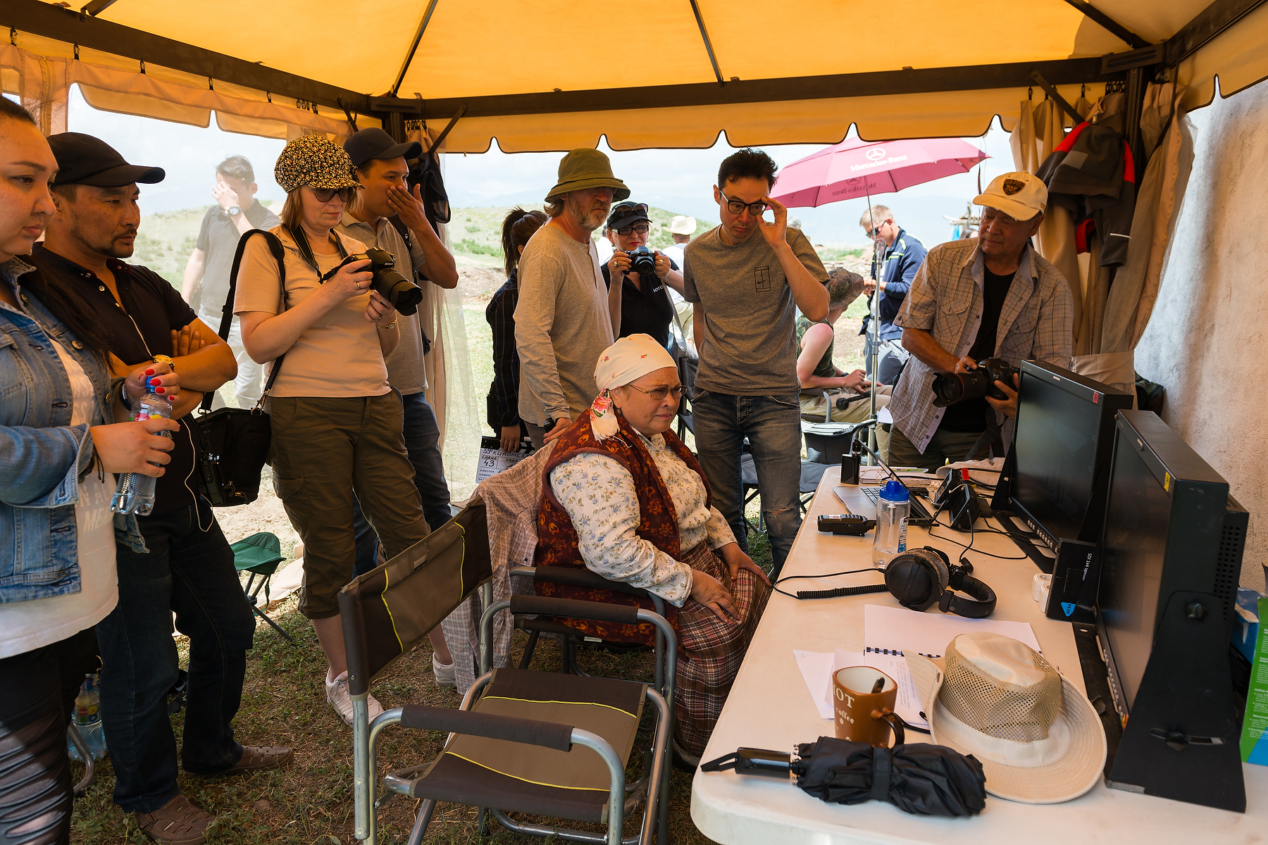 Film crew working inside a practical location with lighting and sound equipment