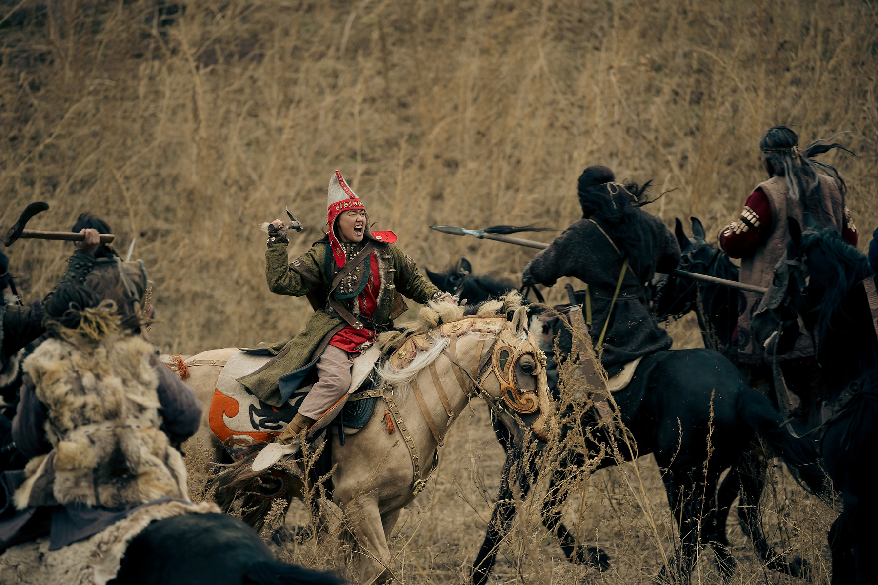Cinematic unit still of mounted performers in a battle scene