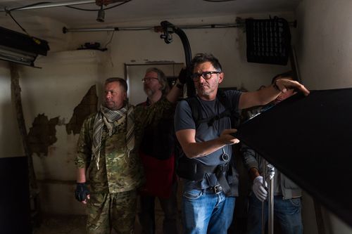Film lighting and camera crew working inside a practical location