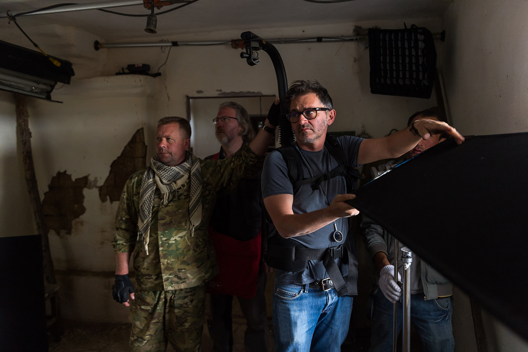 Film lighting and camera crew working inside a practical location