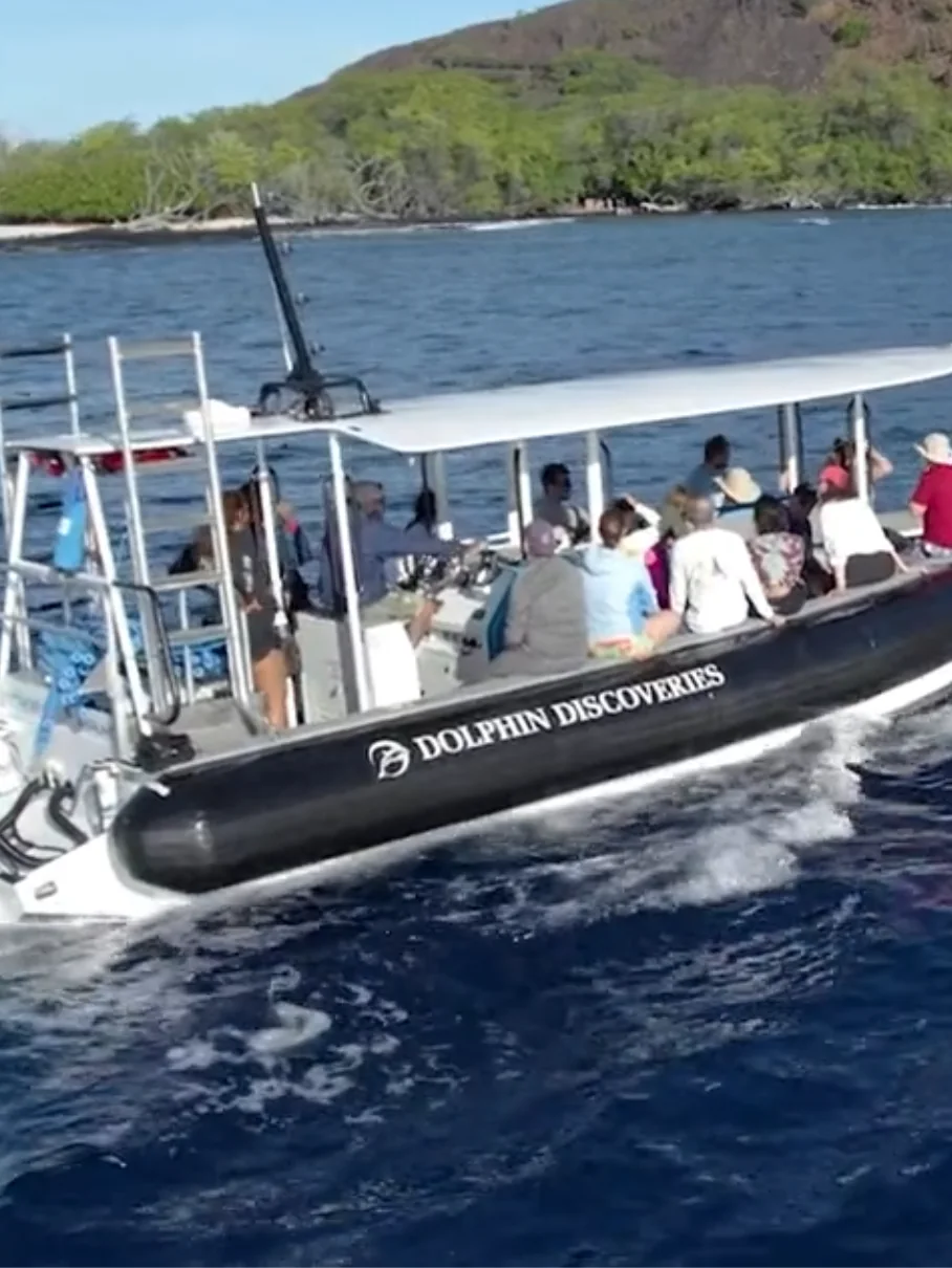 Guests aboard the Dolphin Discoveries flagship boat heading out on a Kona snorkel tour