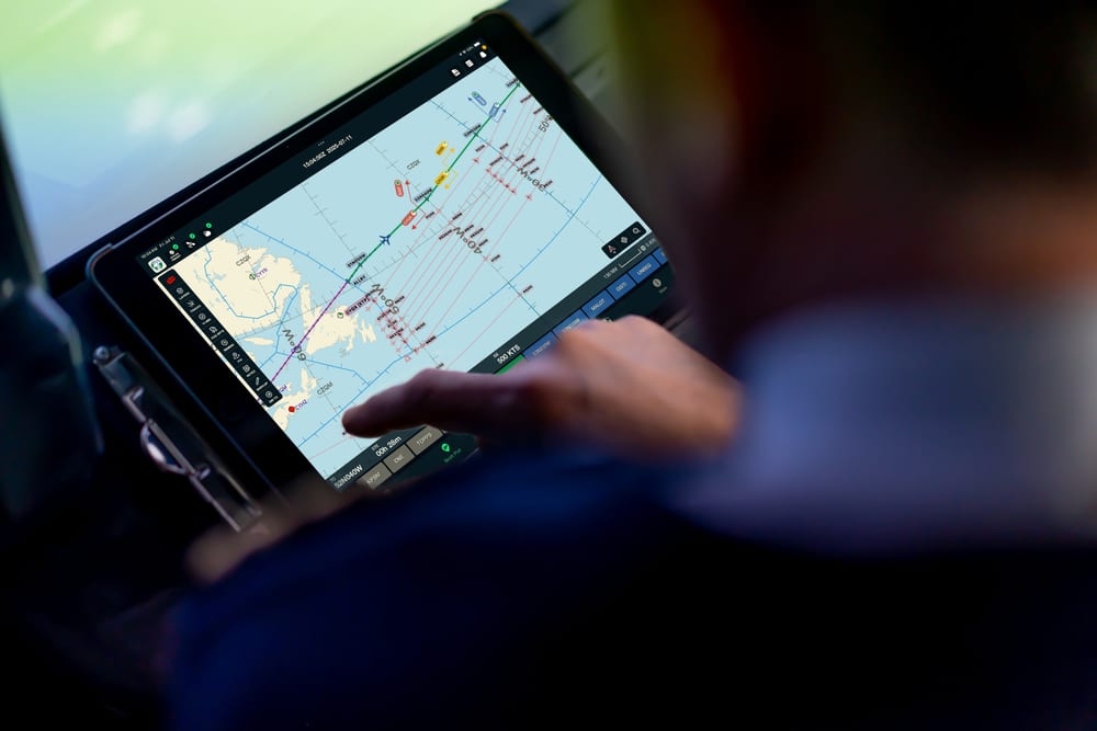 A pilot using Scott Plot oceanic plotting on an iPad in the cockpit.