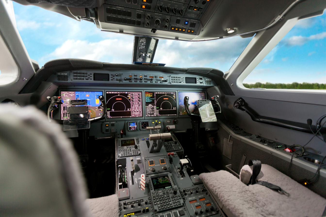 The glass flight deck of a business jet in flight — the cockpit where the Scott IPC app is used.