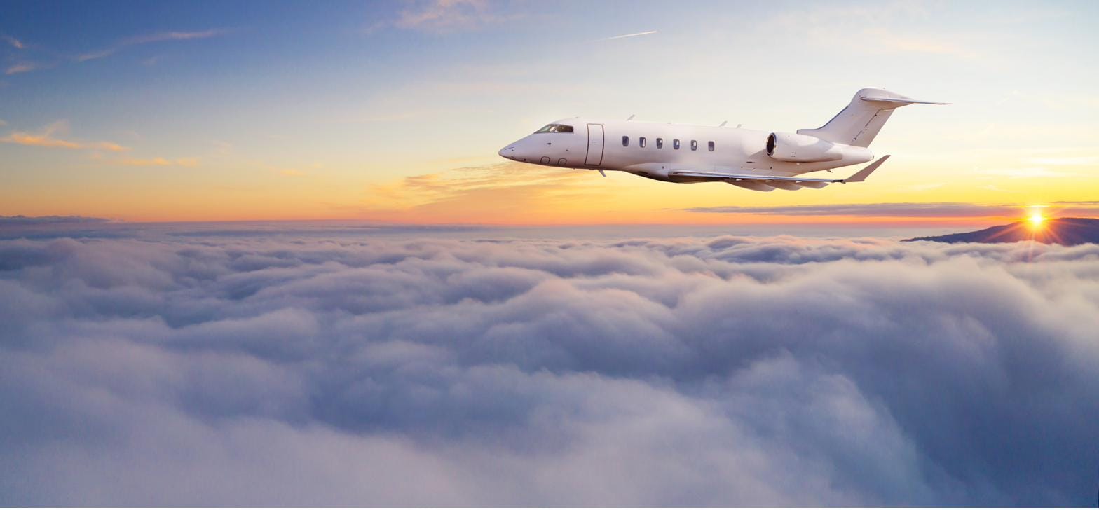 Business jet cruising above the clouds