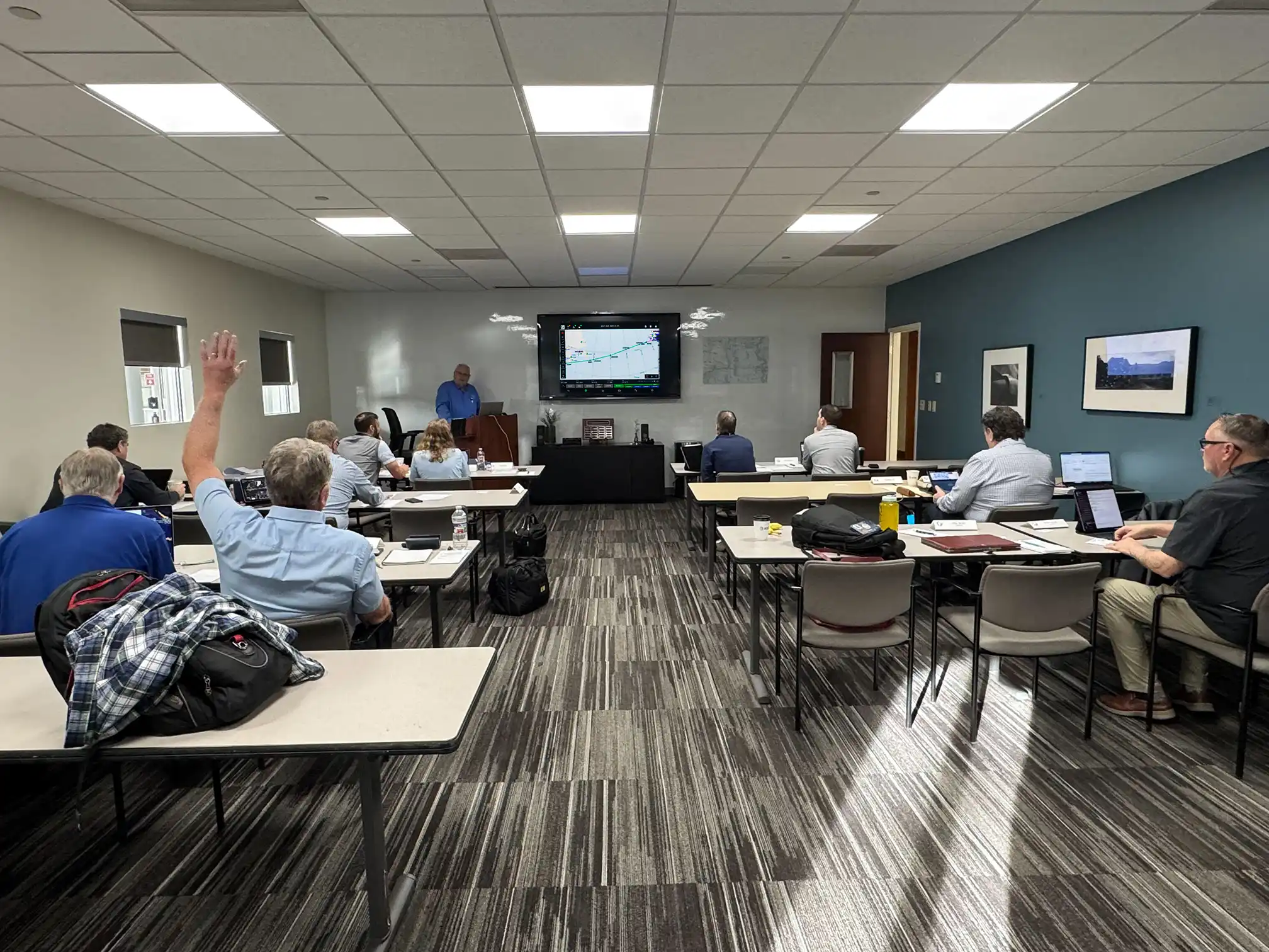Pilots in a Scott IPC international procedures training class with an instructor presenting