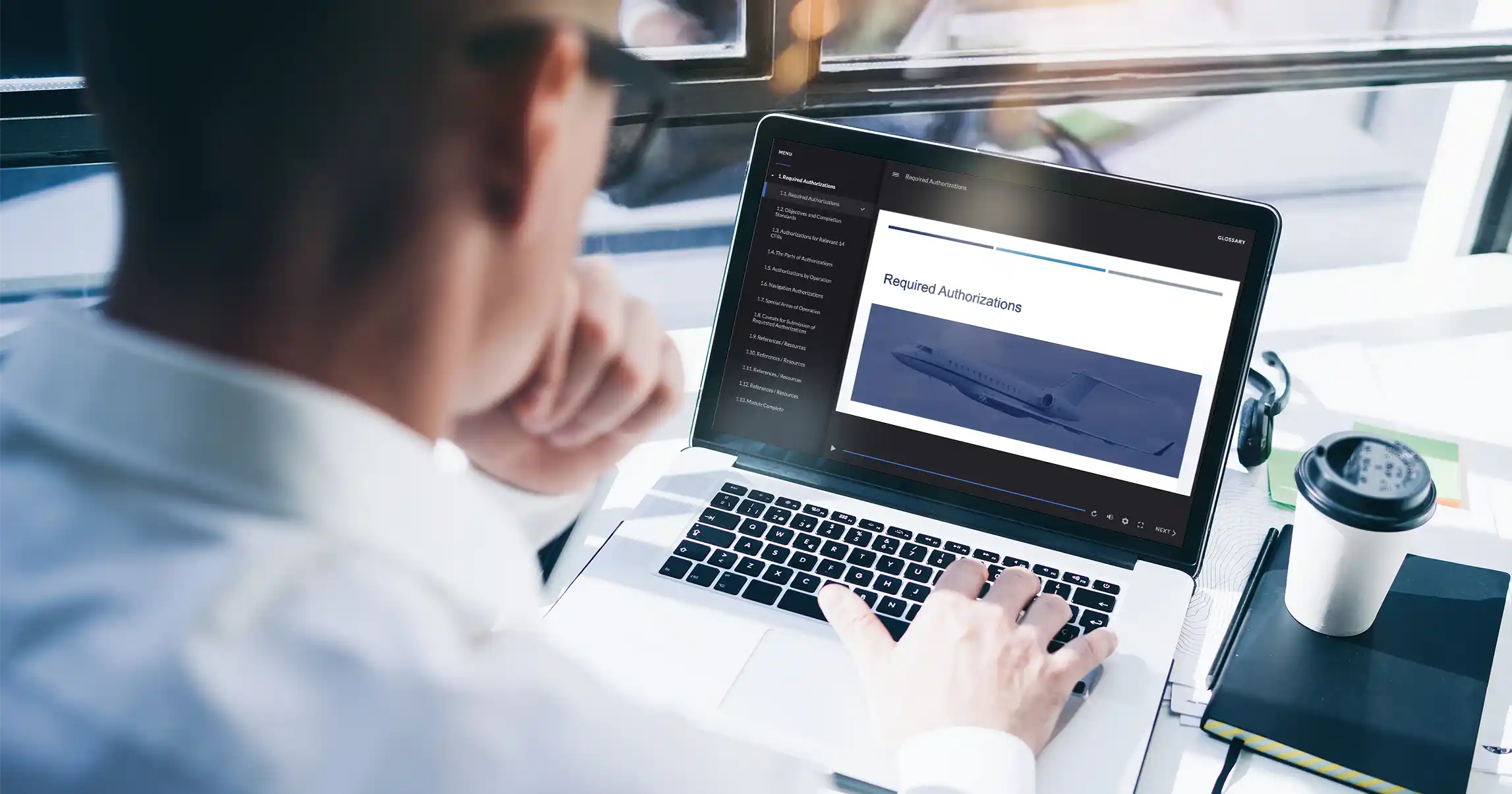 A laptop showing the online International Procedures Training course, open to the Required Authorizations section