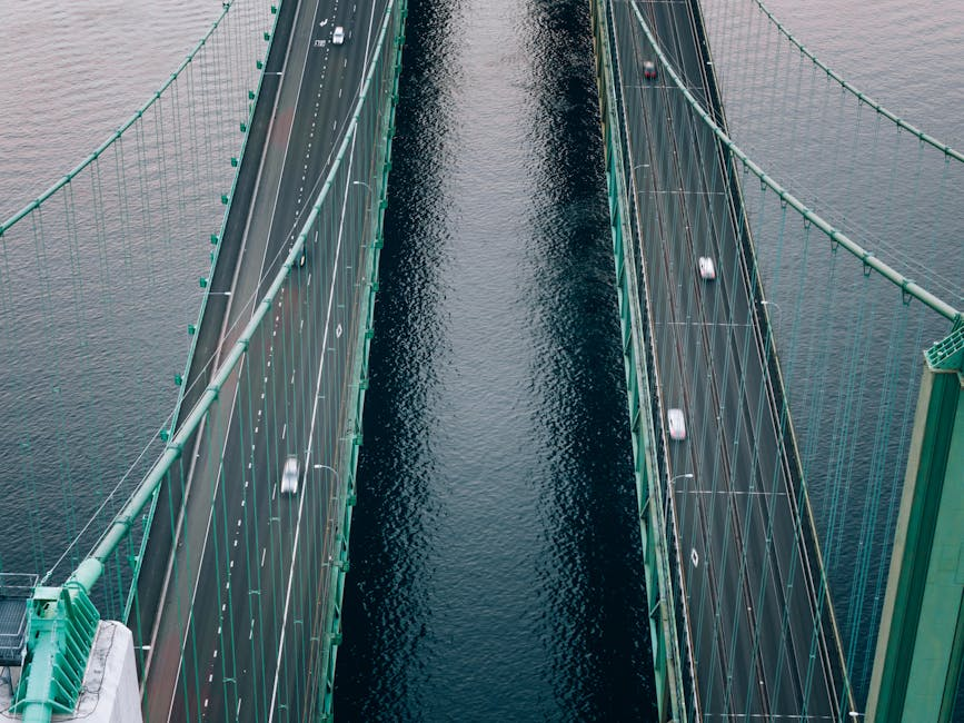 Aerial view of a bridge with vehicles crossing over water, symbolizing connectivity and transportation in Tacoma, WA.