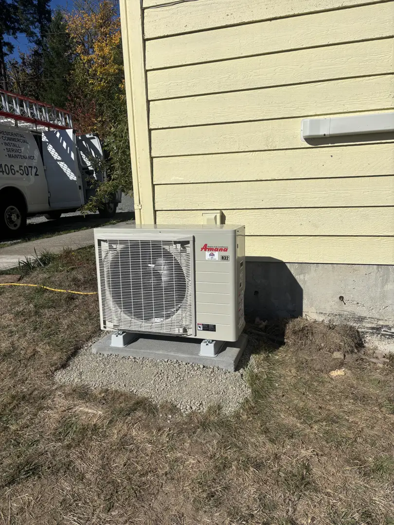 tilted AC condenser pad on muddy soil
