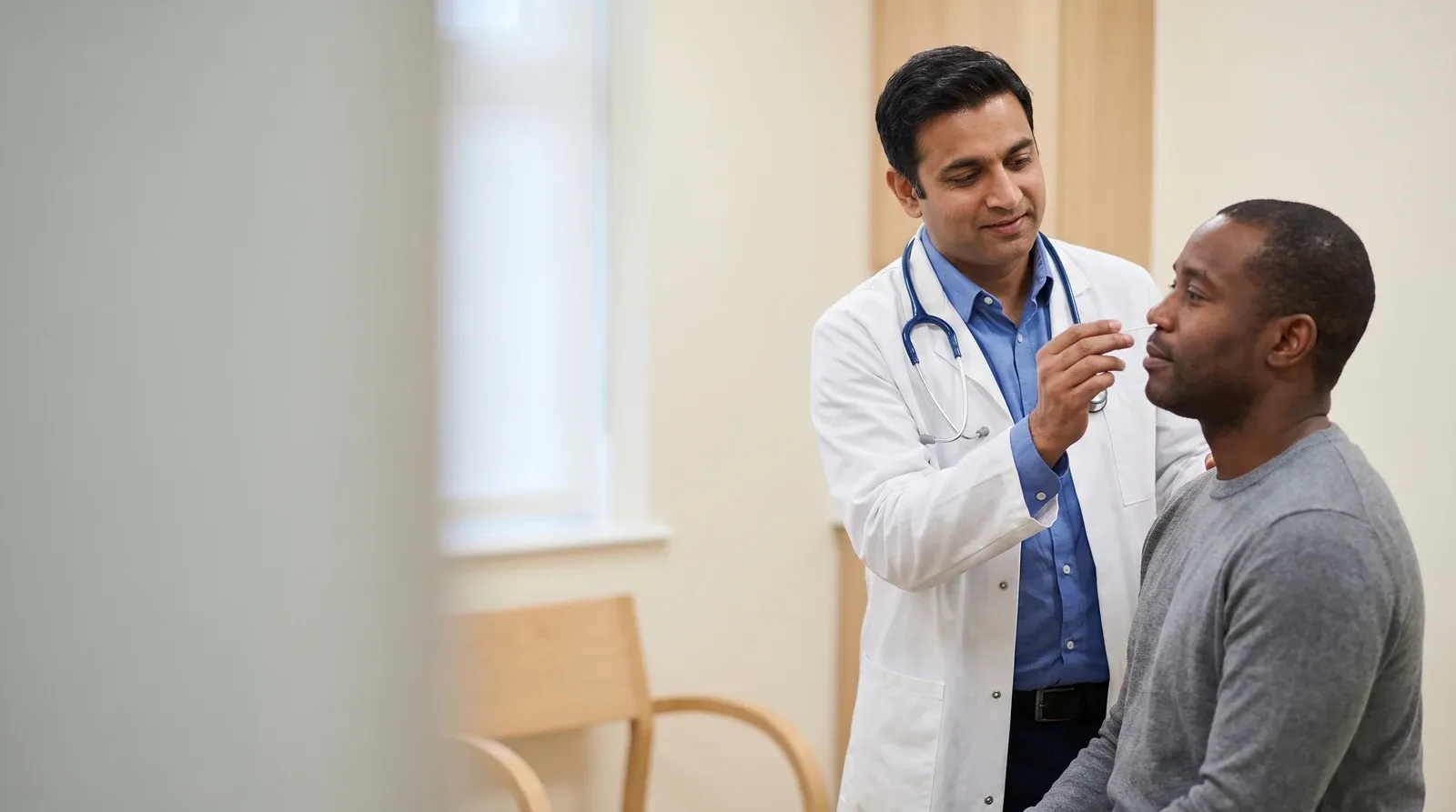 Mother holding child while being seen by a nurse at AllCare urgent care
