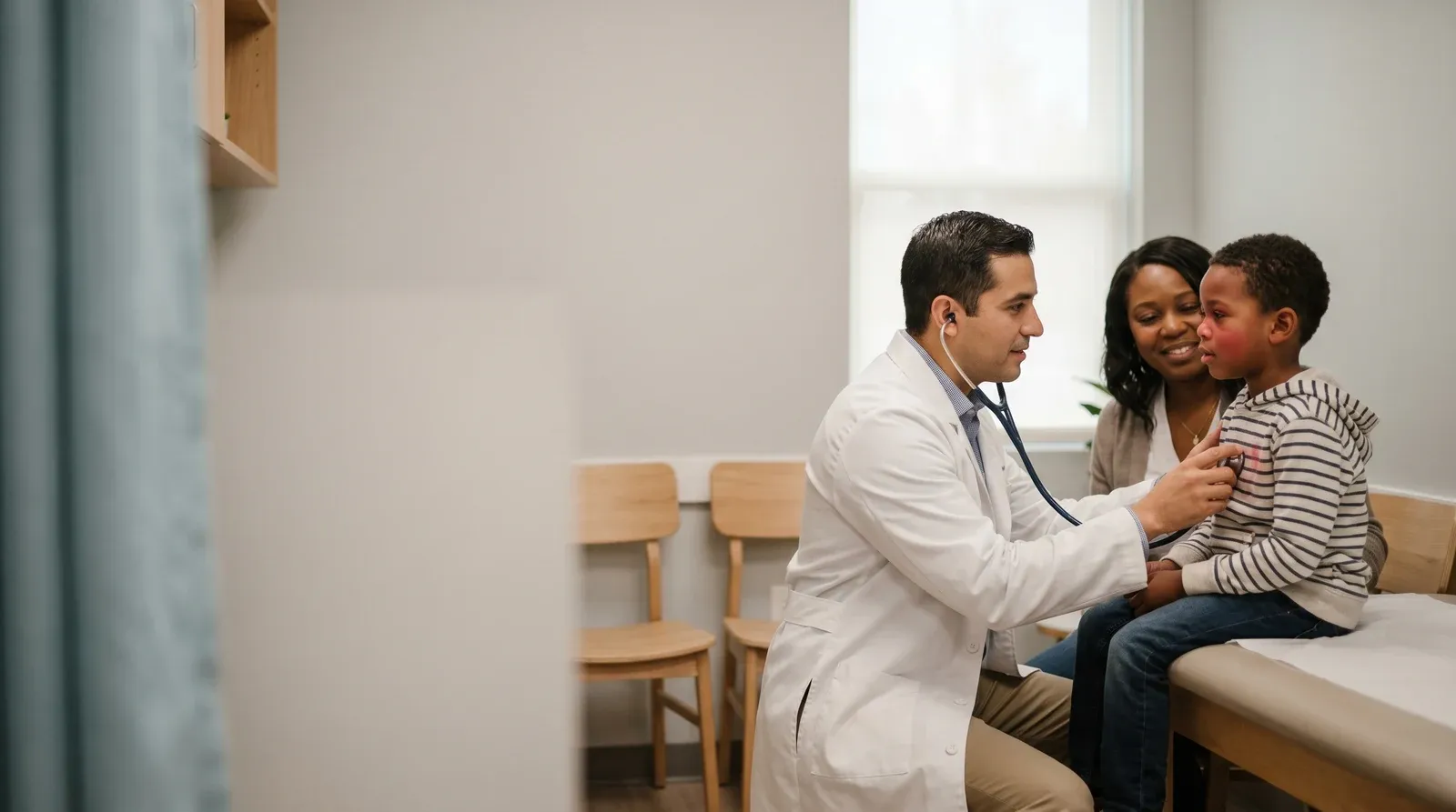 Mother holding child while being seen by a nurse at AllCare urgent care