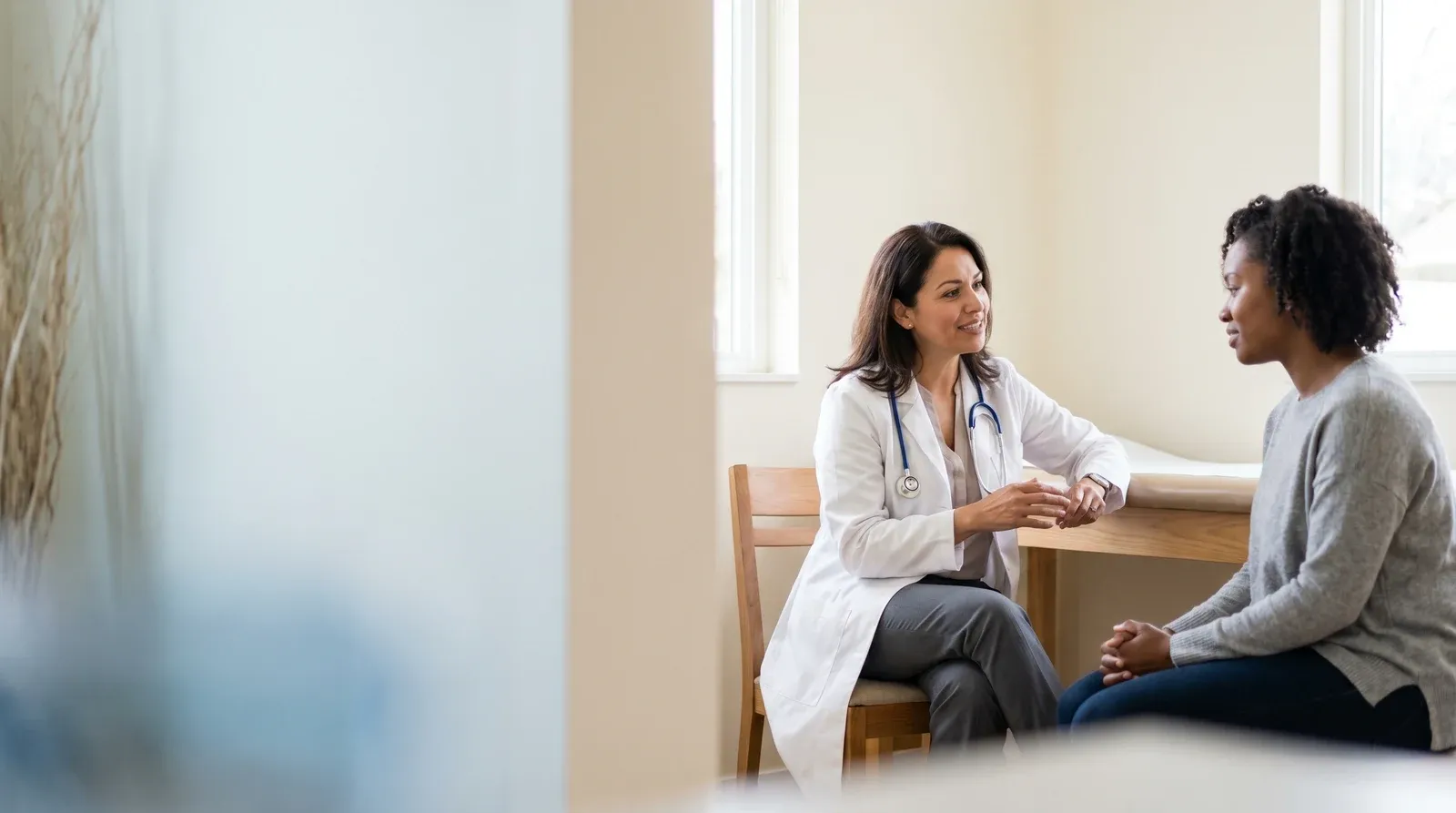 Mother holding child while being seen by a nurse at AllCare urgent care