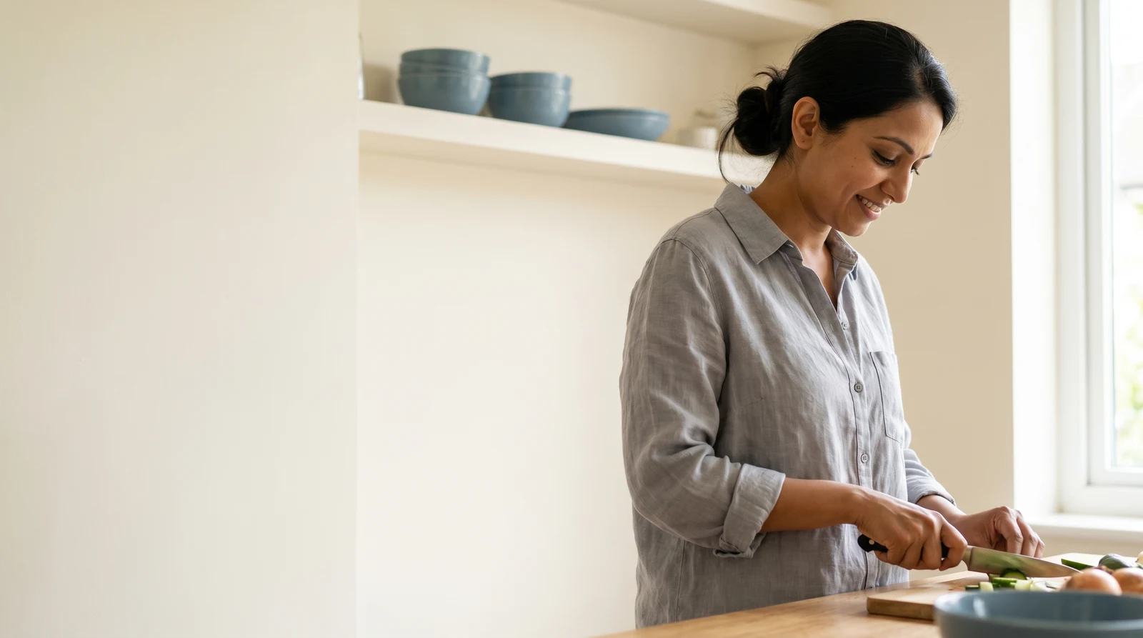 An AllCare team member checking in a patient on a tablet at the front desk