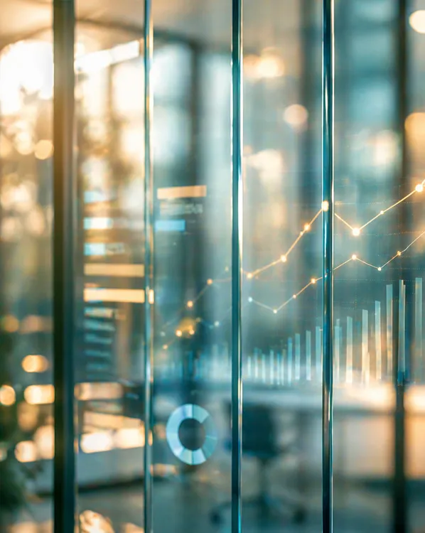 Transparent glass panels with digital analytics graphs and charts in an office setting.