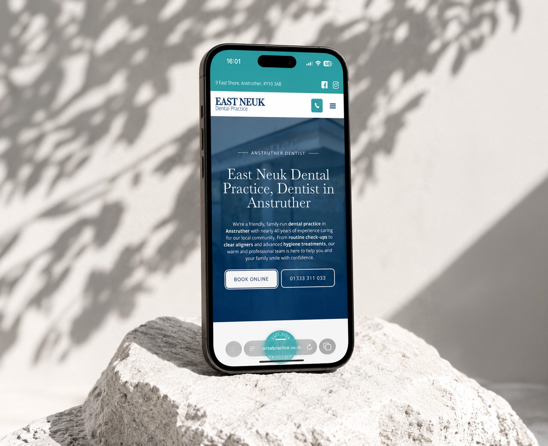 East Neuk Dental Practice mobile website displayed on pale stone