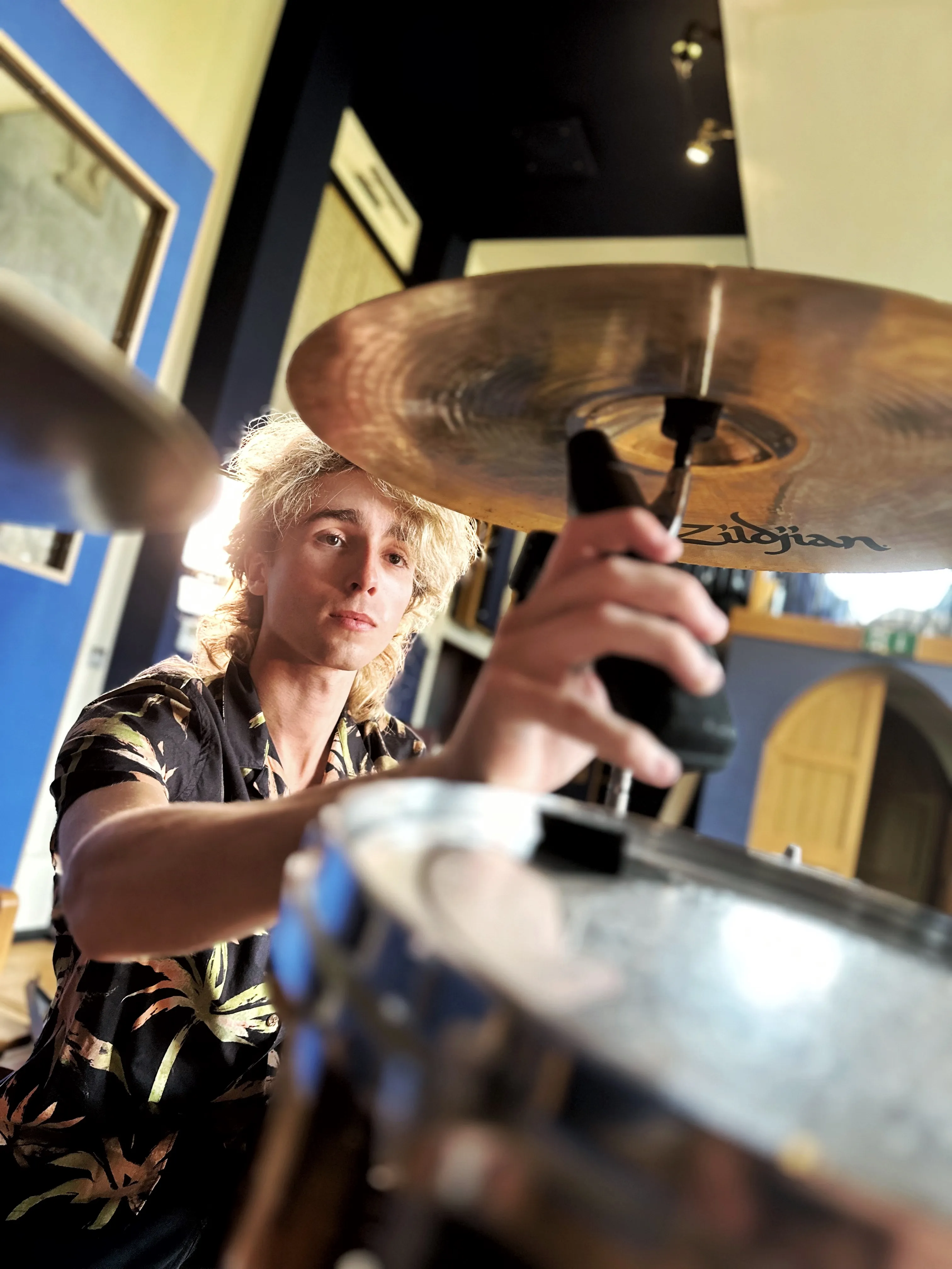 Sam Harding playing drums in a recording studio