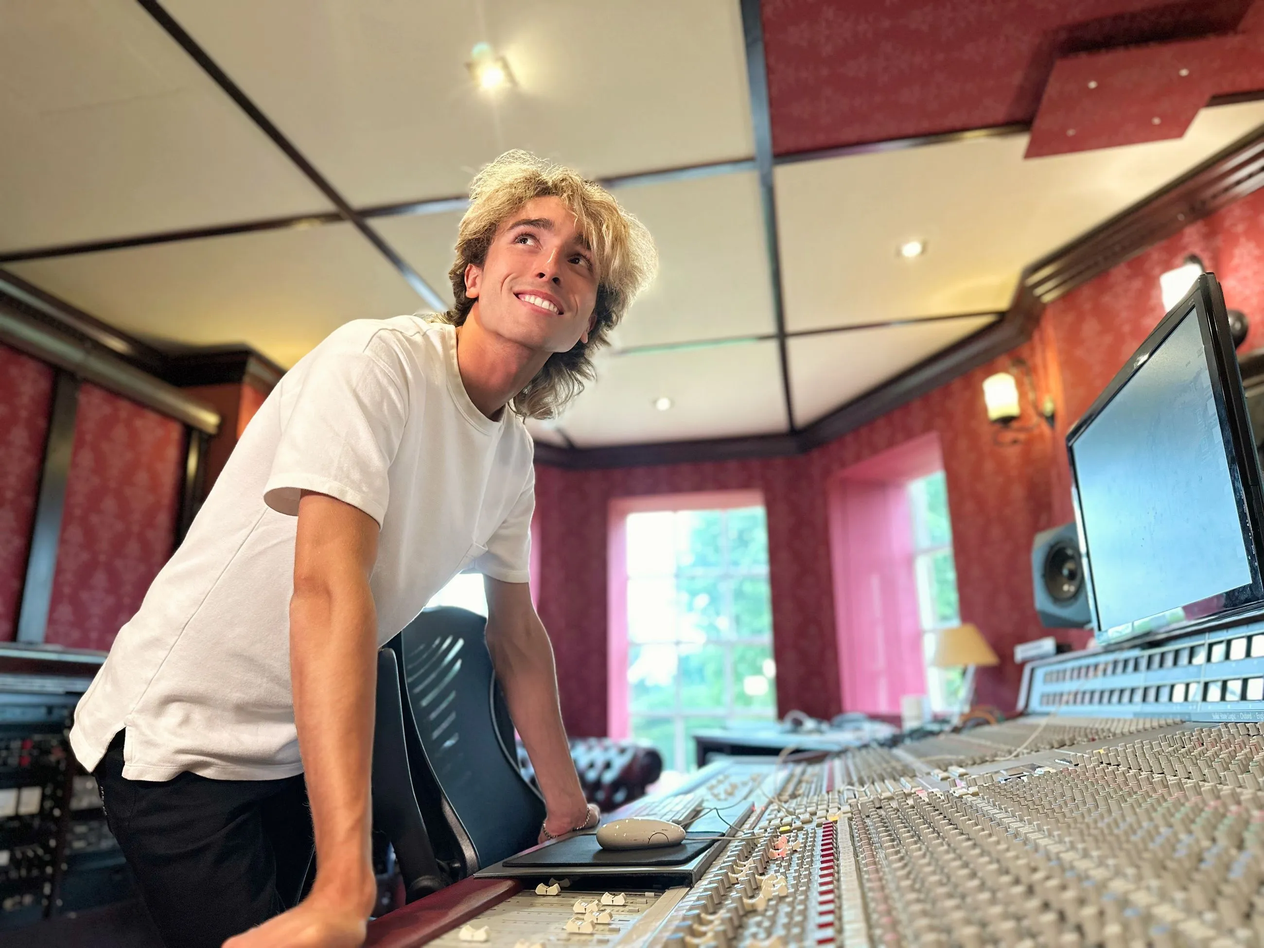 Sam Harding at a recording studio mixing desk