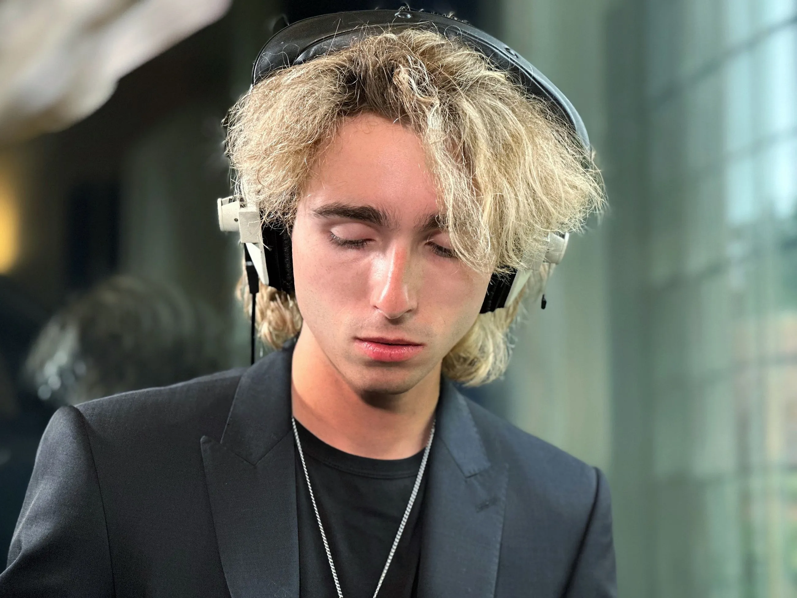 Portrait of Sam Harding wearing headphones