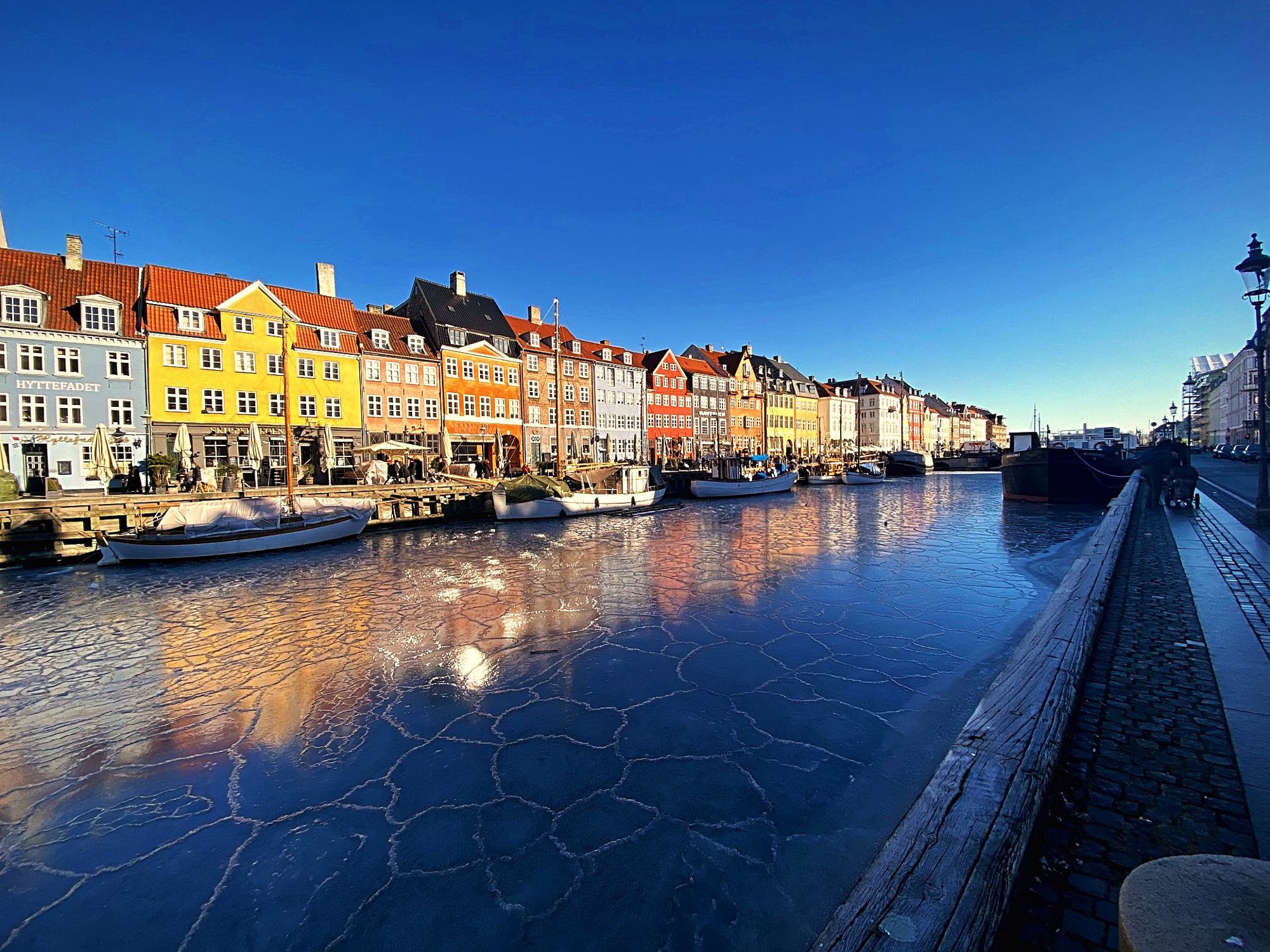 Nyhavn in Copenhagen in winter, the canal frozen below the colored houses