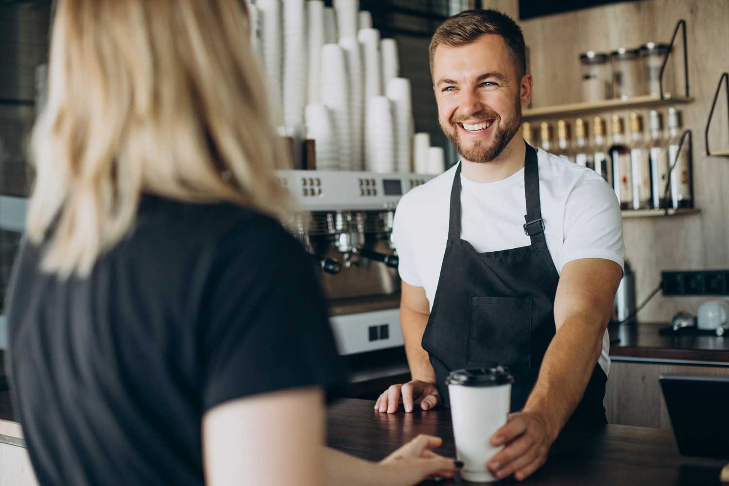 Man serving coffee to woman