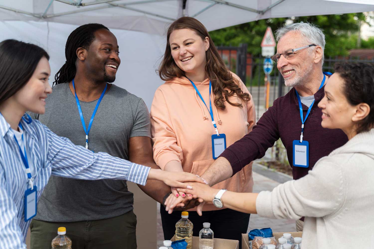 Group of charity workers holding hands
