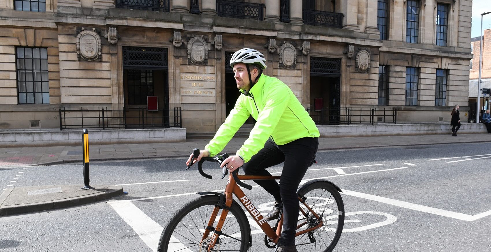person cycling outside hull council building