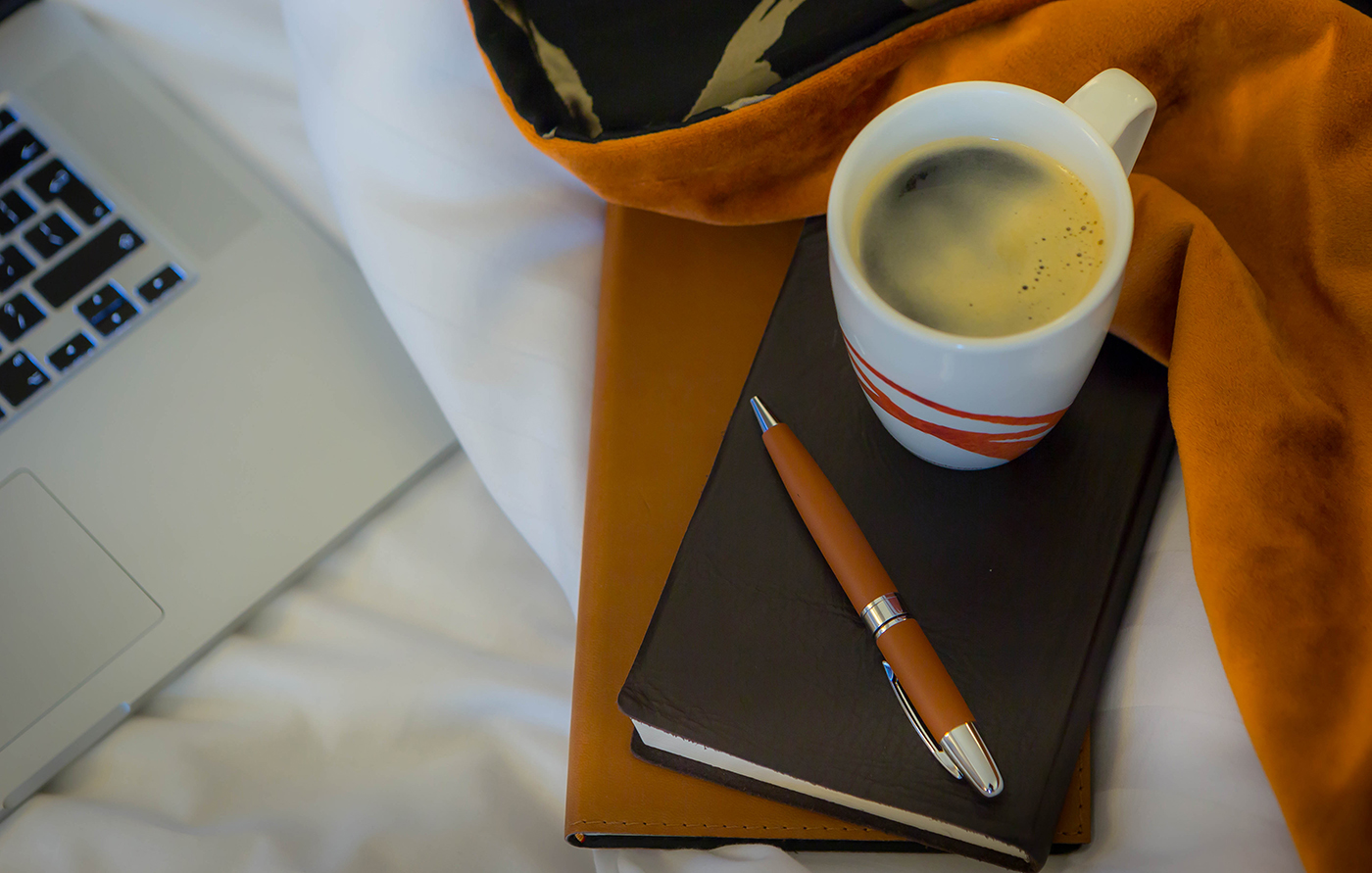Coffee Mug with Pen, Notebook and Laptop on Bed - Corporate Photographer © David Cantwell Photography